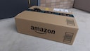 An Amazon package in front of a doorstep