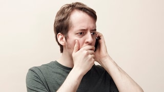 Man on the phone with a shocked expression