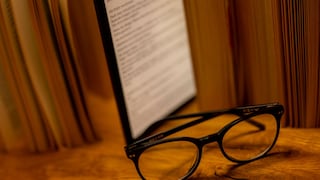 E-book reader sits among books on a table