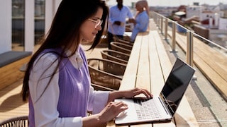 Woman Works on Her Laptop Under the Sunny, Open Sky
