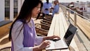 Woman Works on Her Laptop Under the Sunny, Open Sky