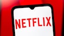 Netflix logo on a smartphone with a red background