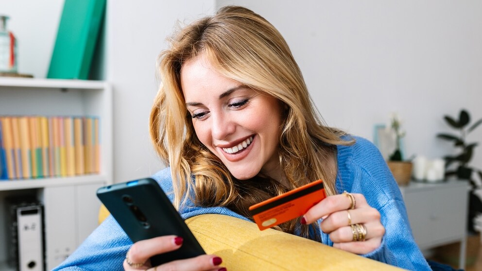 Woman Holding Credit Card and Smartphone