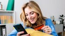 Woman Holding Credit Card and Smartphone