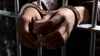 Person in Handcuffs in Jail