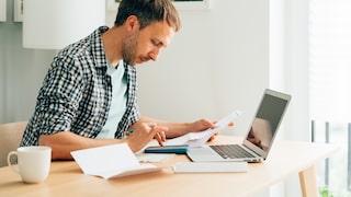 Man Likely Doing Taxes at Table