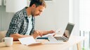 Man Likely Doing Taxes at Table