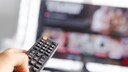 Person Points Remote at TV
