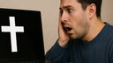 Man Looks Horrified at a Laptop