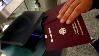 Person Uses Passport at Airport