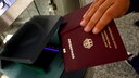 Person Uses Passport at Airport