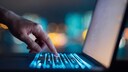 Someone types on a laptop