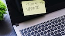 Sticky note on a laptop with the message "Time to Update."