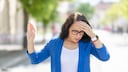 Woman Holding Her Hand to Her Forehead