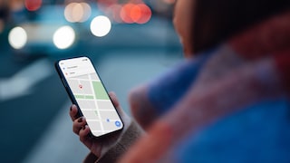 Woman holding a smartphone with a navigation app in her hand