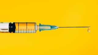 Syringe on Yellow Background