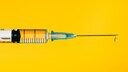 Syringe on Yellow Background