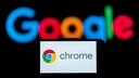 Smartphone with Chrome logo and Google lettering in the background