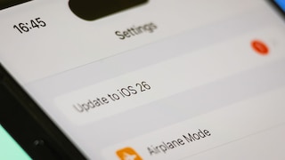 Smartphone with iOS 26 Update Text