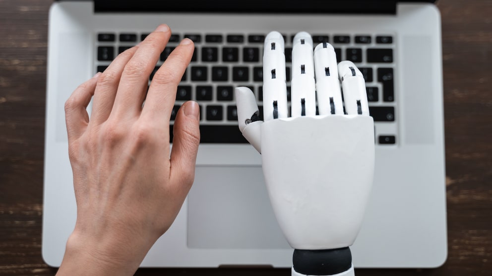 Robot Hand and Human Hand Typing on Computer
