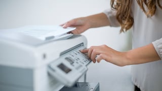 Woman Standing in Front of Printer