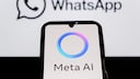 Smartphone with Meta AI logo and WhatsApp logo in the background