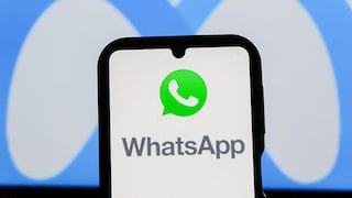 Smartphone with WhatsApp logo and Meta logo in the background