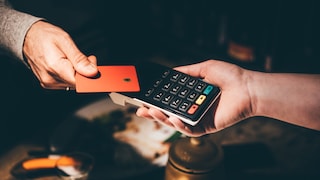 Holds the credit card up to a card reader