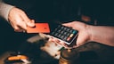 Holds the credit card up to a card reader