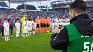 A man uses an iPhone during an MLS game in the U.S.