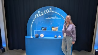 Editor Rita Deutschland stands in front of a shelf with the Alexa+ logo and various Echo models.