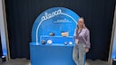 Editor Rita Deutschland stands in front of a shelf with the Alexa+ logo and various Echo models.