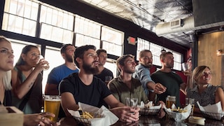 People watch sports in a bar