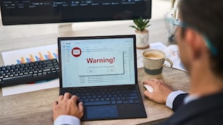 Man at Computer with Warning