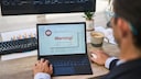 Man at Computer with Warning
