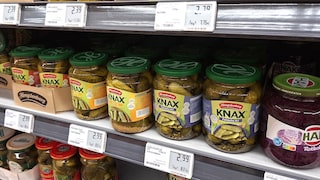 Jars of pickles in the supermarket with digital price tags