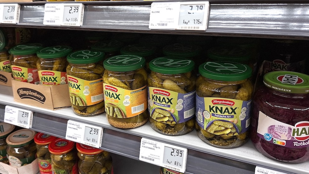 Jars of pickles in the supermarket with digital price tags
