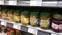 Jars of pickles in the supermarket with digital price tags