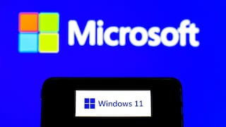 Smartphone Displays Windows 11 Logo Against Microsoft Background