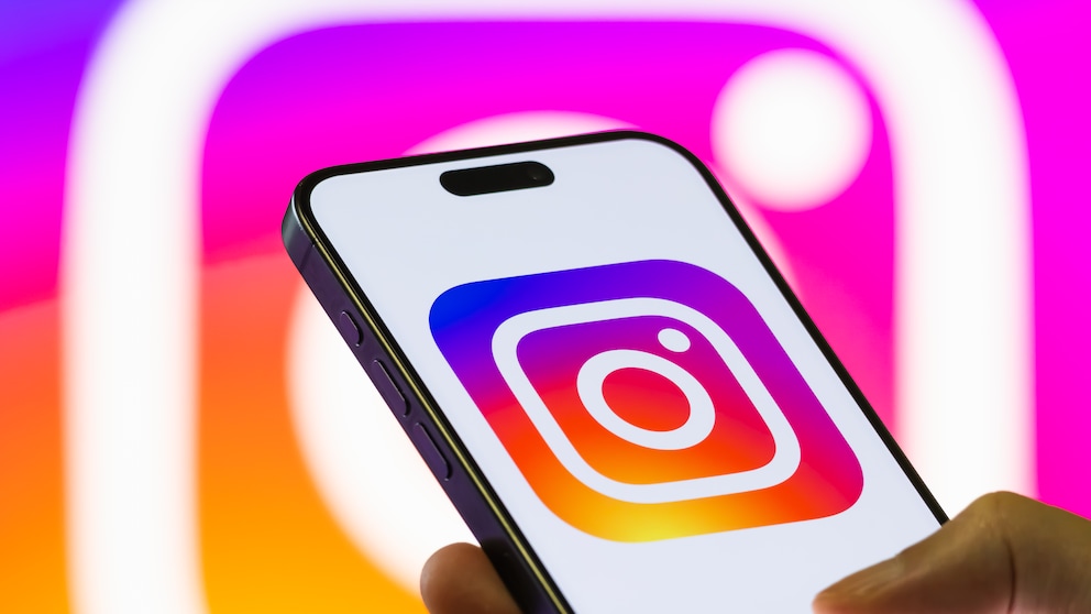 iPhone Displays Instagram Logo Against Instagram Logo Background