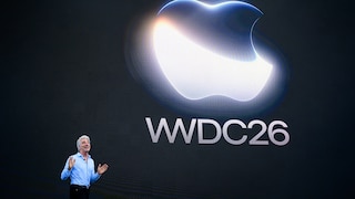 Craig Federighi on stage at Apple HQ with WWDC26 graphics in the background