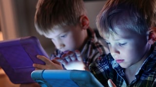 Children each looking at a tablet