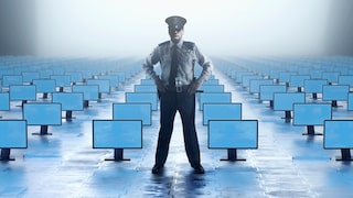 Police Officer Stands in a Room Full of Computer Monitors