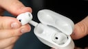 Man Holding Apple AirPods Pro.