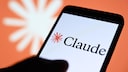 Smartphone with Claude branding, with the Claude logo in the background.