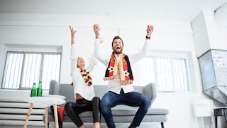 Germany fans celebrating on a couch.