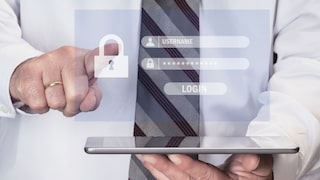 Man holding a tablet with a virtual window displaying password entry fields.