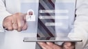 Man holding a tablet with a virtual window displaying password entry fields.