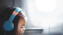 Young Girl on Airplane Wearing Headphones