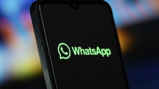 Smartphone Displays WhatsApp Logo and Text